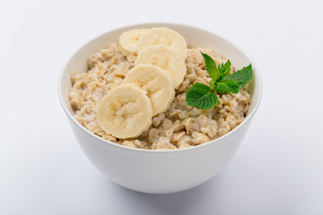 Oatmeal with banana and mint on white background NOT isolated