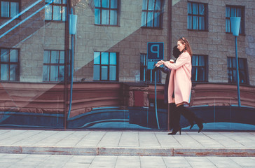 Woman is late for work. She hurries, drinks coffee on the go and looks at her watch.