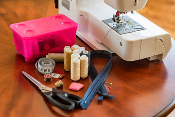 Bobbins, scissors, tape measure and a sewing machine
