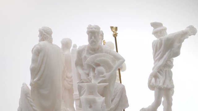 Many greek gods statue rotating on a stand. Closeup shot.