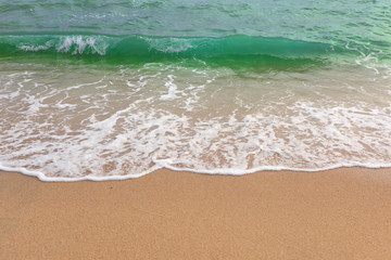 Sand beach water surf. Green sea wave.