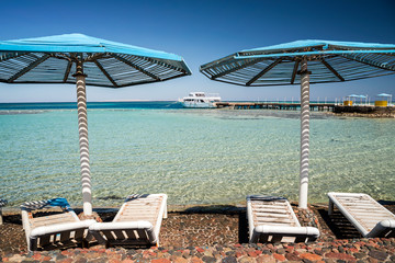 Blue sun umbrellas for tourist at the beach resort, Hurghada, east Egypt