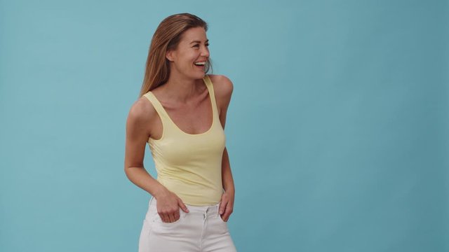 Stunning Woman Laughing with Both Hands on Her Pockets and then Crossing them