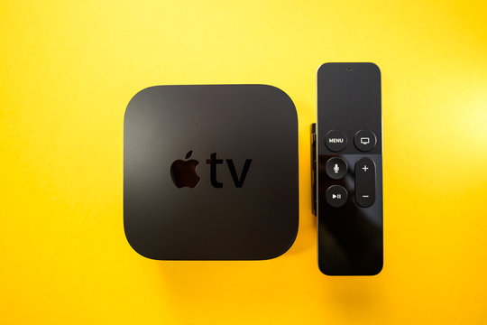 Paris, France - 25 Mar 2019: Directly above view of Apple TV 4k player with Siri remote control assistant Apple TV plus subscription film series documentaries - includes the logotype on the cover