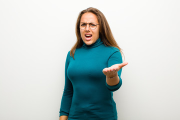 young woman looking angry, annoyed and frustrated screaming wtf or what‚Äôs wrong with you...