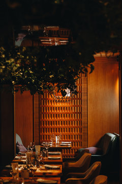 tableware Glasses, flower fork, knife served for dinner in restaurant with cozy interior