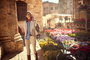 Buying Flowers. business woman buying flowers at flower shop on the street..