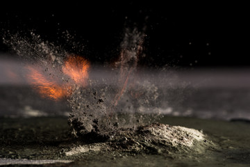 Fototapeta premium burning sand and a splash of water on a black background, the fifth element