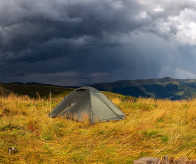 Beautiful mountain landscape in stormy weather with a tourist tent. Carpathian mountains of Ukraine. Holidays in the mountains.