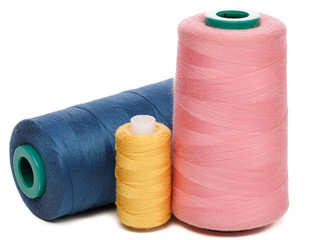 Group of spools of color sewing threads isolated on white background