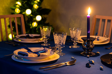 Christmas table setting with christmas tree in background