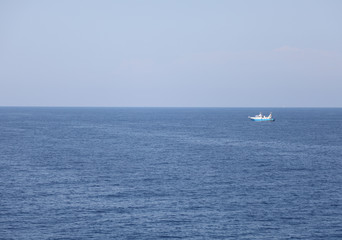 water of the ocean and the blue sky with fishing boat