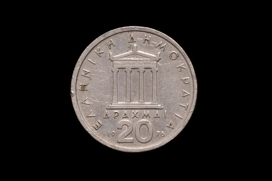 Republic of Greece old 20 drachmai coin from 1976, reverse showing the Parthenon. Isolated on black background