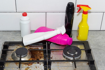 Dirty, top of the gas stove with bits of food. House cleaning.