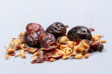 pile of dry rose hips on a wooden table