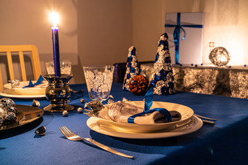 Christmas table decoration with wrapped gifts in background