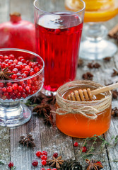 Pomegranate lemon and honey cranberries on a wooden background. Cinnamon and other healthy spices.