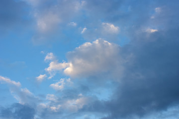 Naklejka na ściany i meble Sunny day on the celestial horizon appeared clouds, harbingers of good weather.
