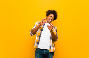 young black man feeling disgusted and nauseous, backing away from something nasty, smelly or...