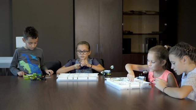 Children in the classroom make figure from the designer