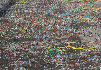 Confetti scattered on the street after the parade of masks