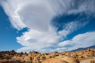 unique Lenticular Sierra Wave cloud formations over Sierra Nevada mountains California desert rock formations