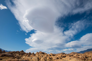 unique Lenticular Sierra Wave cloud formations over Sierra Nevada mountains California desert rock formations