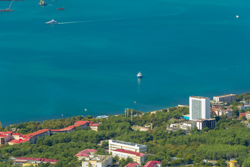 Scenic view of Gelendzhik city district and sea bay. Sunny day. Hotels, coast, ships in Black sea and horizon in frame. Vacation on resort.
