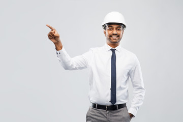 architecture, construction business and people concept - smiling indian male architect in helmet...
