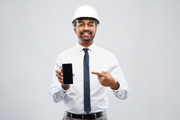 architecture, construction business and people concept - smiling indian male architect in helmet...