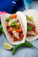 Closeup of tortilla wraps with tex-mex chicken fajitas, vertical shot, selective focus