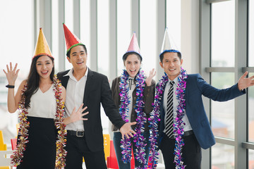 Young Asian Colleague friends having singing, dancing and fun in office together. Group of business people hanging out and enjoy which smiling and felling happy, New year party at the company office