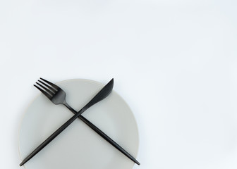 Empty plate and modern cutlery isolated on white background. S