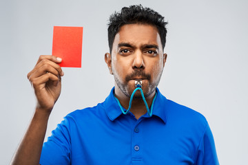 sport, caution, game and football concept - indian referee whistling and showing red penalty card