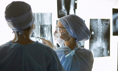 Two female women medical doctors looking at x-rays in a hospita