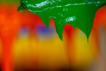 several dripping colors ink on handle printers in tee shirt factory hang on the storage