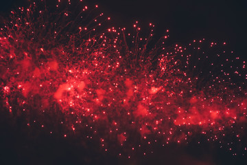 Fireworks background.  Red lights. Fireworks display on dark sky background.