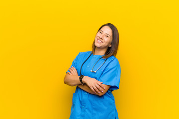 laughing happily with arms crossed, with a relaxed, positive and satisfied pose isolated against...