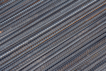 Industrial background. Brand new steel rebars at a construction site. Preparation for pouring concrete. Construction of buildings of reinforced concrete.
