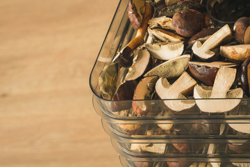 Vegetables dryer on wooden table with wooden background. Preparing for drying mushrooms. 