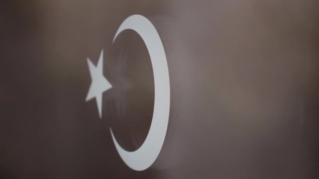 Fantastic view of the moon and star sign (Turkish flag) sticker on the train window against the blurred background.