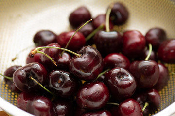 Fresh cherries in fruit washing colander