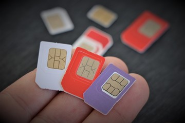 Close up of some international SIM cards from all over the world. Concept of international travel and roaming connection service.  