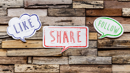 Speech bubbles on wooden background : like share follow