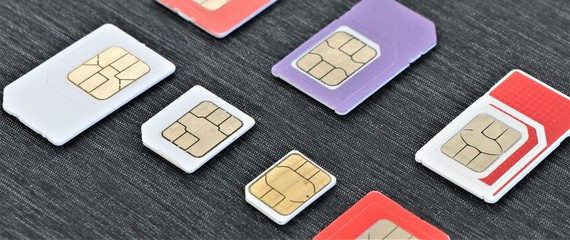 Close up of some international SIM cards from all over the world. Concept of international travel and roaming connection service.  