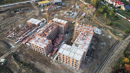 Construction of a building with tower cranes top view.