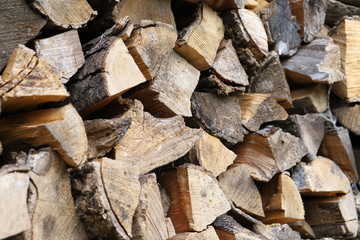 Dry chopped oak firewood, put into containers for sale to consumers as fuel.