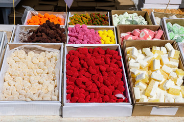 Mixed types of traditional Turkish delight or lokum and jelly candies displayed for sale at an weekend street food market