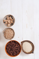 Flakes, sugar, seeds semi-cook for porridge close up in white key