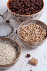 Flakes, sugar, seeds semi-cook for porridge close up in white key